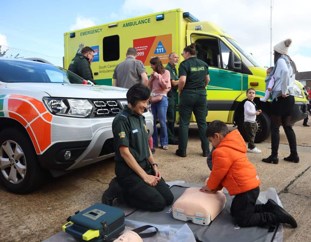 A child learning CPR with a Paramedic.