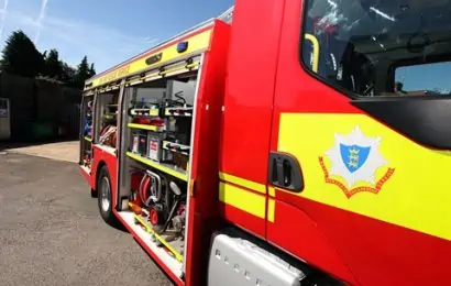 image of side of fire engine with compartments open and focus on the rbfrs crest