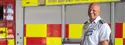 Banner of firefighter stood in front of a fire engine for wholetime recruitment campaign