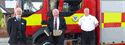 Councillor angus ross, air commodore rick peacock edwards and che scott in front of fire engine