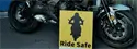 motorcycle with ride safe poster