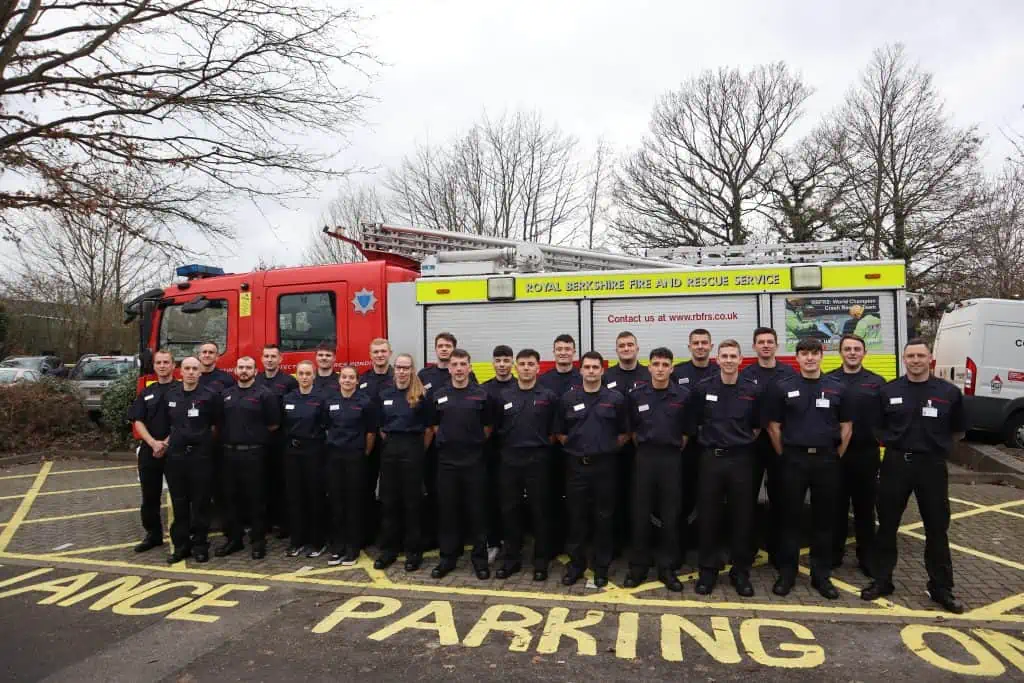 The Firefighter Apprentices stood next to a Fire Engine.