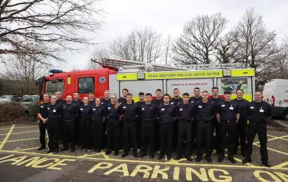 The Firefighter Apprentices stood next to an appliance