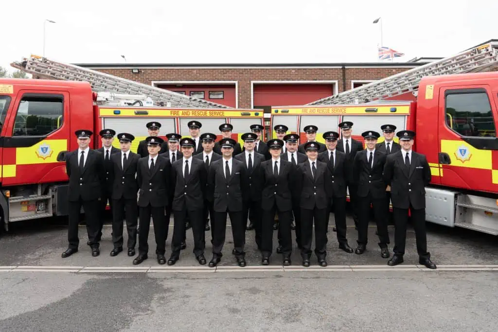 Image of the 23 apprentices in front of two Fire Engines.
