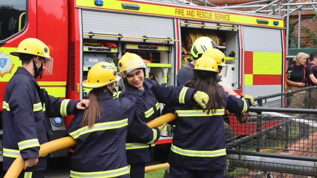 Interns use a hose reel