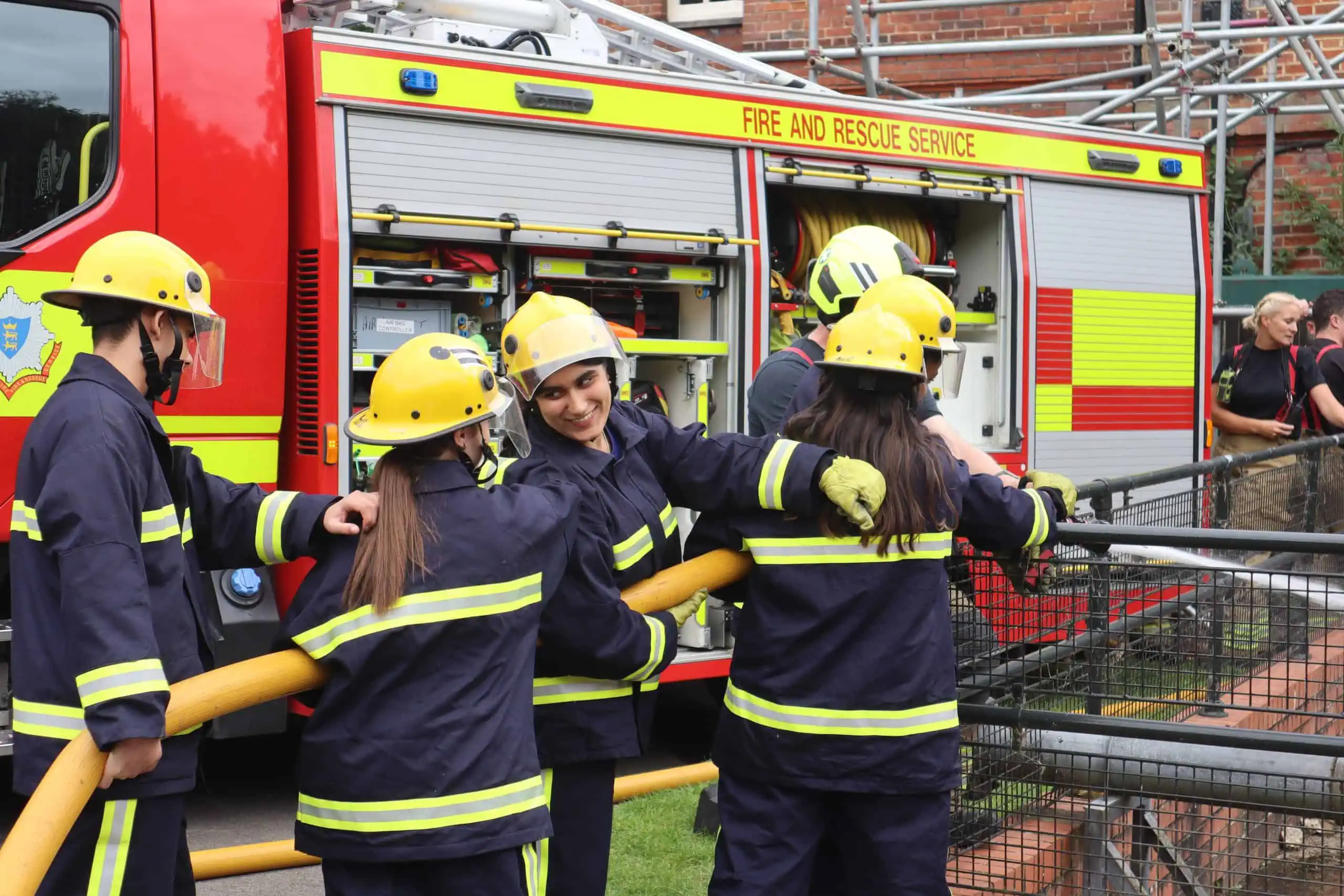 Interns use a hose reel