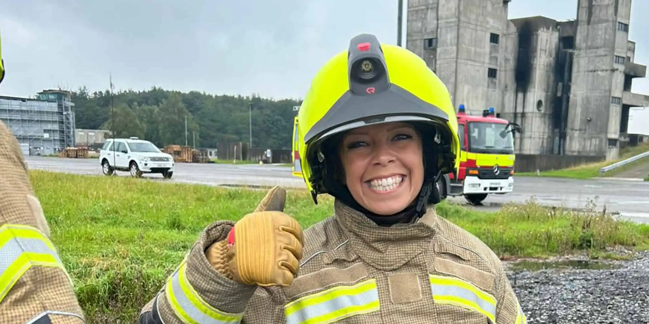 Firefighter with thumbs up at training exercise