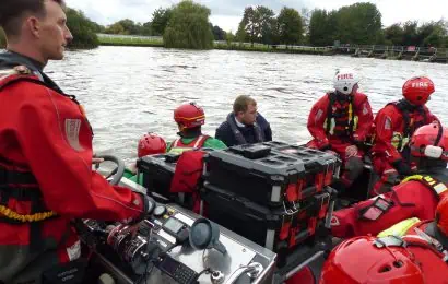Firefighters on a boat in a river