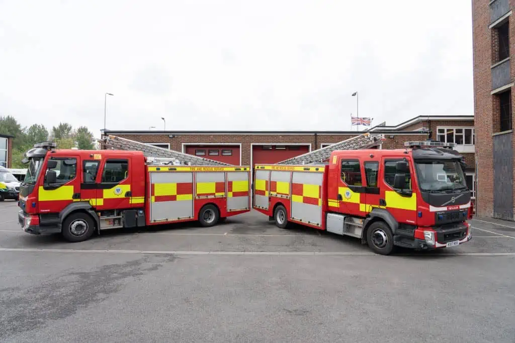 Newbury fire station with two fire engines park in front. 