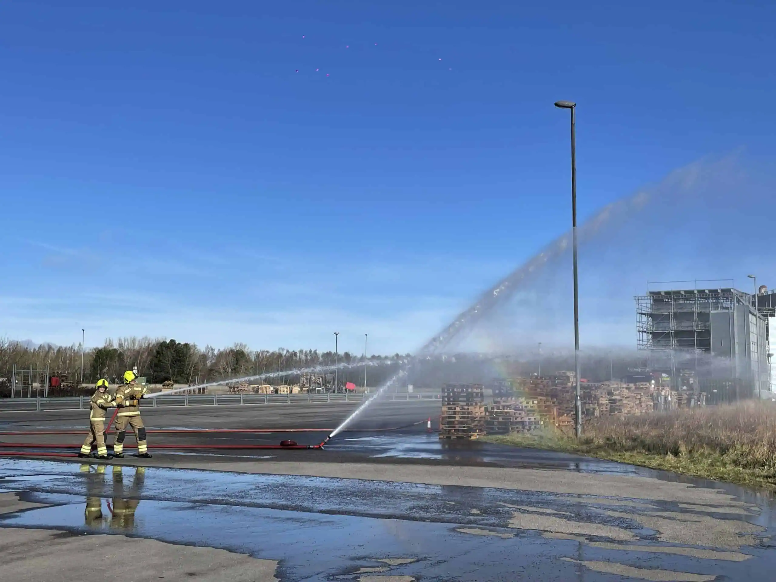 Firefighters spraying water during a training exercise