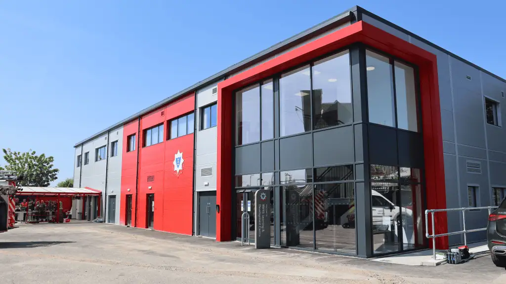 Royal Berkshire Fire and Rescue Service station with modern glass and red exterior.