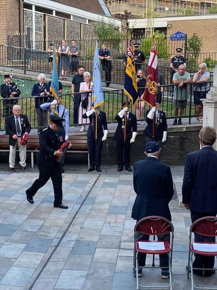 Station Manager Borham walking to place the wreath at the base of the Bracknell War Memorial