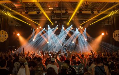 Pictured is a band performing to a crowd.