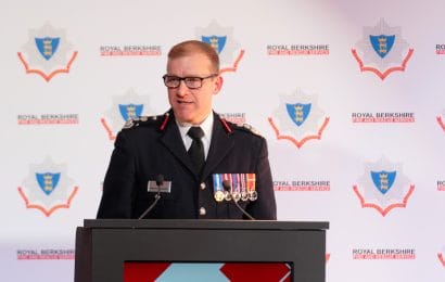 Wayne Bowcock, Chief Fire Officer, speaking at the Awards Ceremony in 2024 on the podium in front of an RBFRS banner