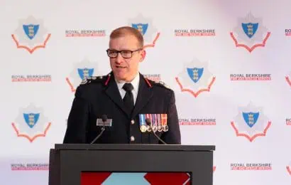 Wayne Bowcock, Chief Fire Officer, speaking at the Awards Ceremony in 2024 on the podium in front of an RBFRS banner