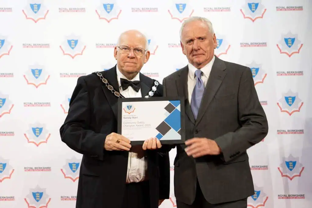 Sandy and the Chair of the Royal Berkshire Fire Authority, Councillor Jeff Brooks, holding an award