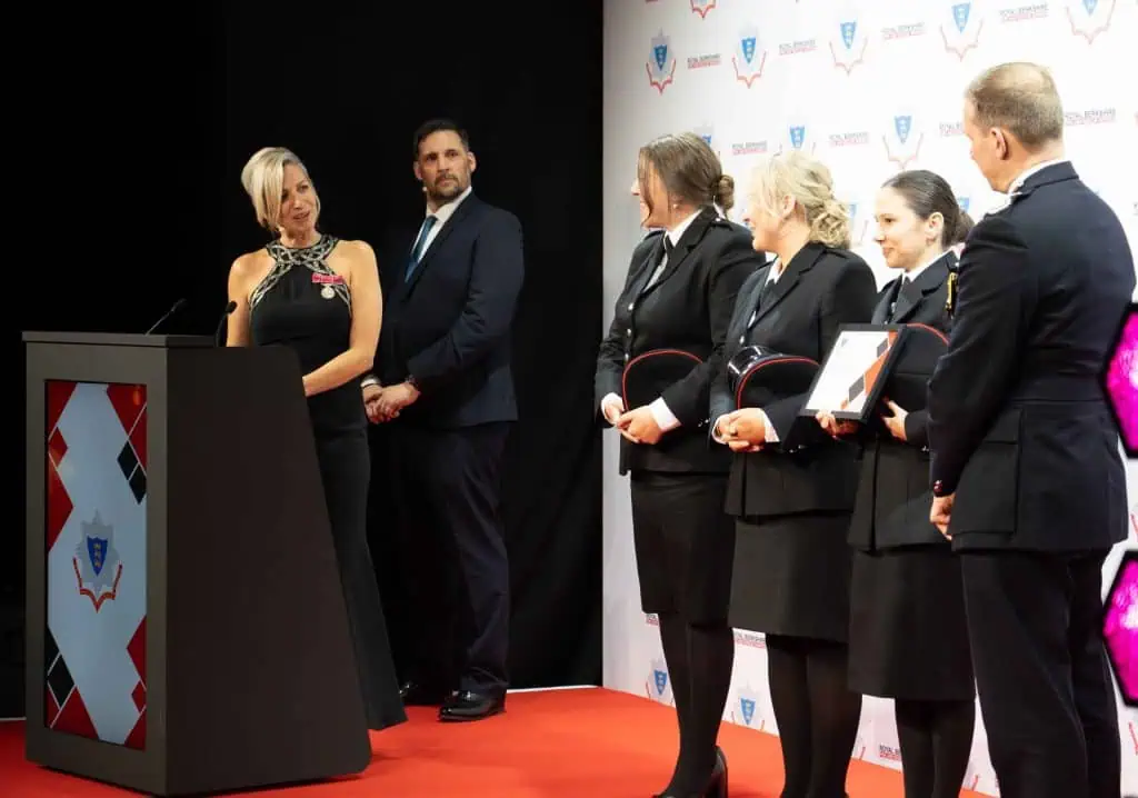A group of people on stage receiving an award