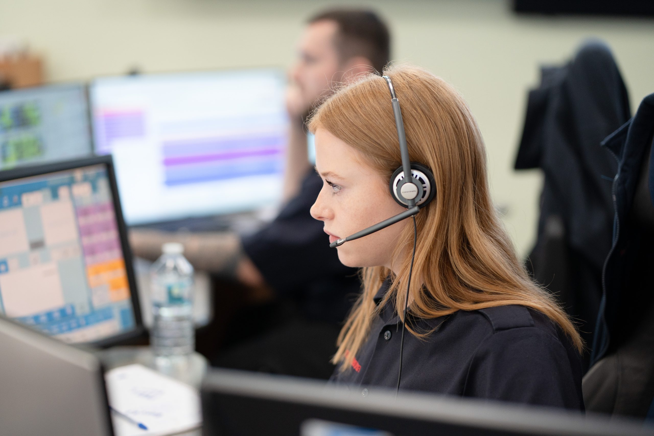 A member of staff from Thames Valley Fire Control Service using a headset.