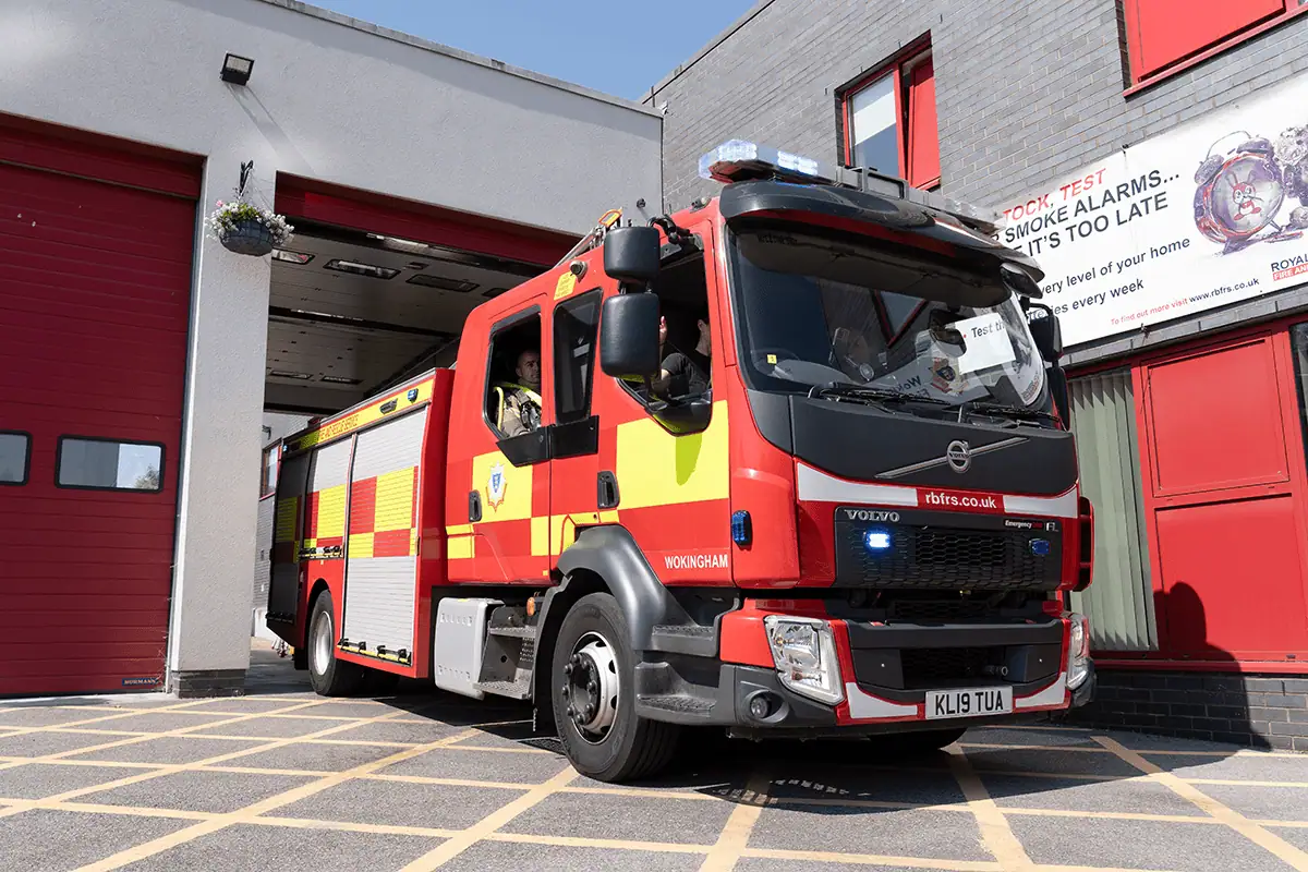 A fire engine leaving a station