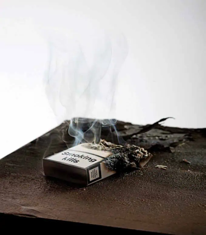 a burnt cigarette box with smoke