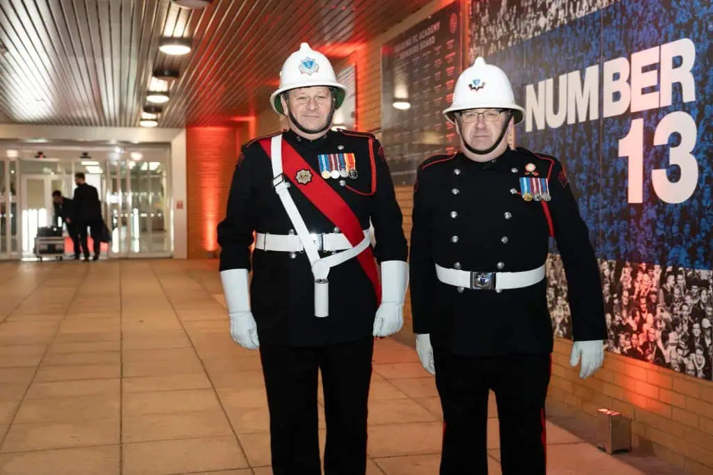 Two staff members stand outside the event