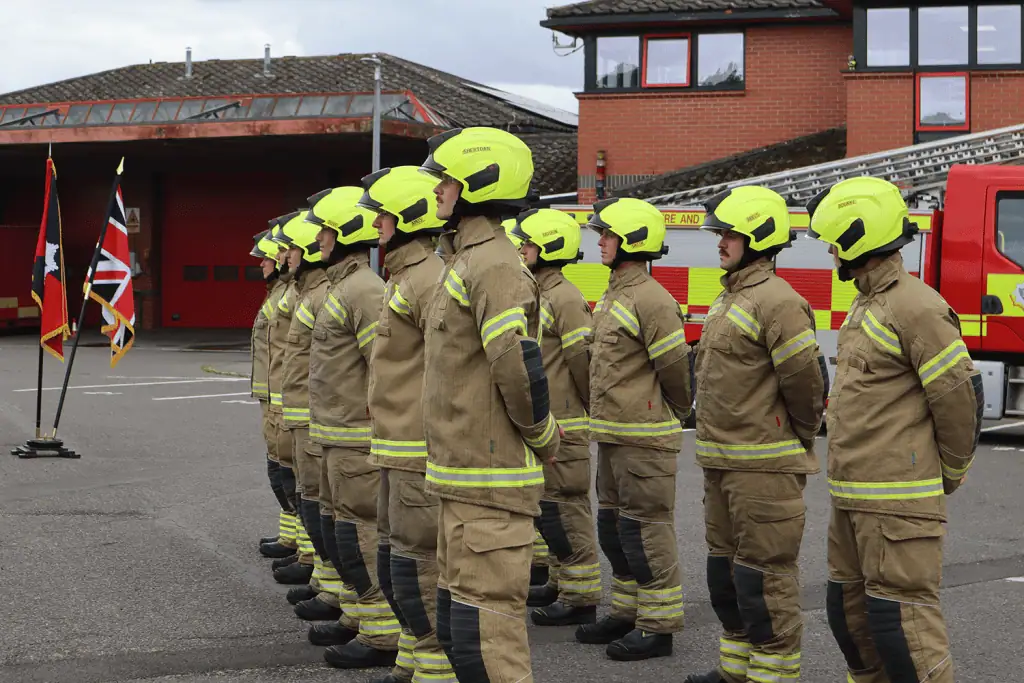 Firefighters lined up outside a fire station